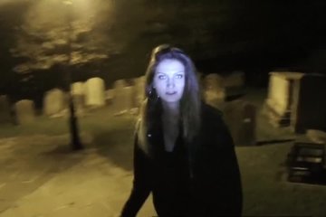 Police officer helps a girl lost in a graveyard